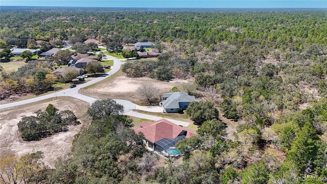 birds eye view of property featuring a view of trees