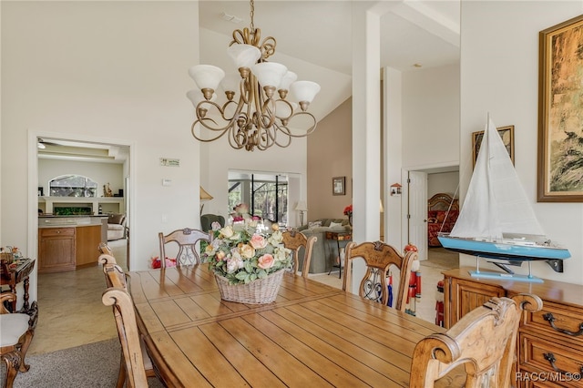 dining space with a notable chandelier and high vaulted ceiling