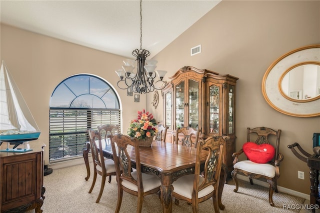 dining space featuring baseboards, visible vents, high vaulted ceiling, an inviting chandelier, and carpet flooring