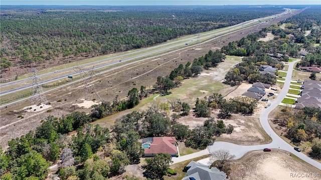 birds eye view of property featuring a wooded view