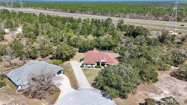 drone / aerial view featuring a view of trees