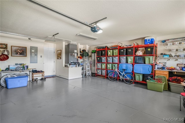 garage with electric panel and a garage door opener