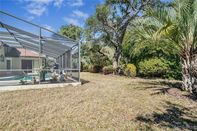 view of yard with an outdoor pool and a lanai