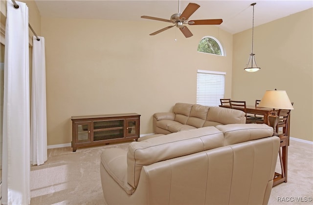 living room featuring light colored carpet, high vaulted ceiling, and ceiling fan