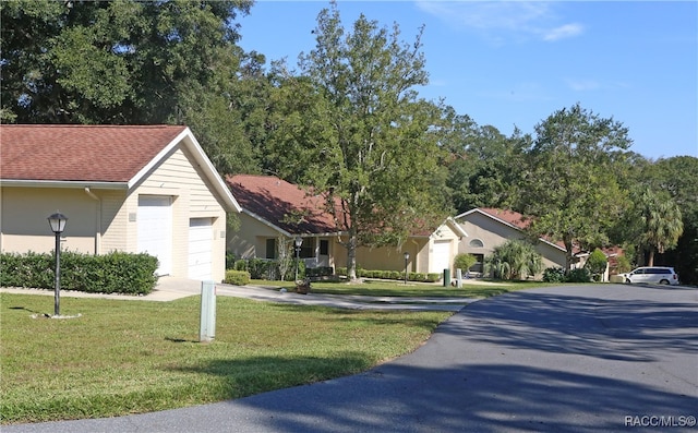 view of front of house with a garage and a front lawn