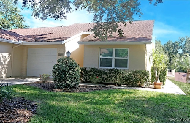 view of front of house with a front yard and a garage