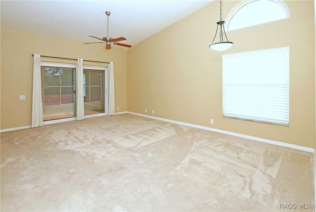 unfurnished room with ceiling fan, lofted ceiling, and carpet floors