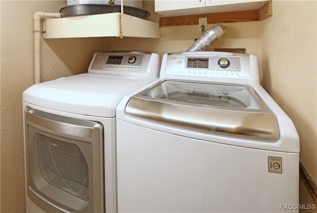 clothes washing area with washer and clothes dryer