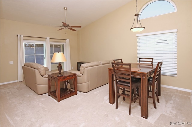 dining area with light carpet, ceiling fan, and a healthy amount of sunlight