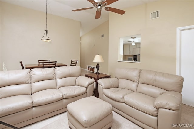 living room with light carpet, high vaulted ceiling, and ceiling fan