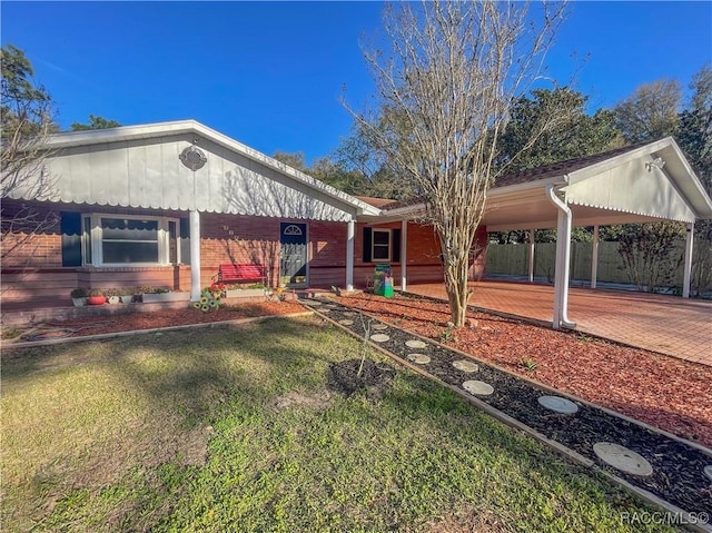 ranch-style house with brick siding and a front yard