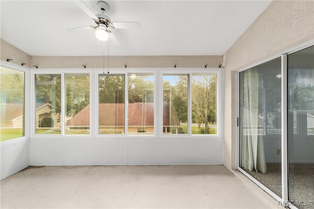 unfurnished sunroom with ceiling fan and a healthy amount of sunlight