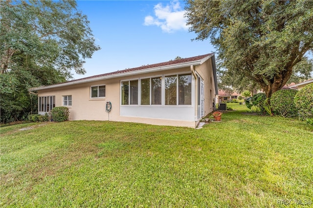 rear view of property featuring a yard