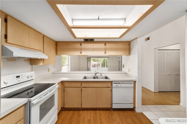 kitchen featuring light wood-type flooring, white appliances, sink, and light brown cabinetry