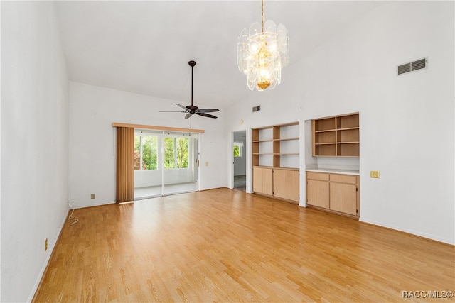 unfurnished living room with ceiling fan with notable chandelier, light wood-type flooring, and high vaulted ceiling