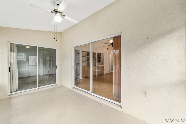 interior space with ceiling fan