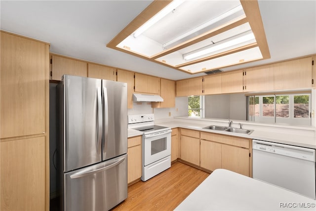 kitchen featuring light brown cabinets, white appliances, light hardwood / wood-style floors, and sink