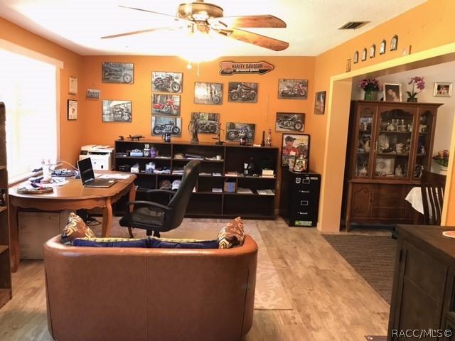 office featuring ceiling fan and light hardwood / wood-style flooring