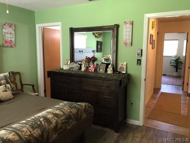 bedroom with dark hardwood / wood-style flooring