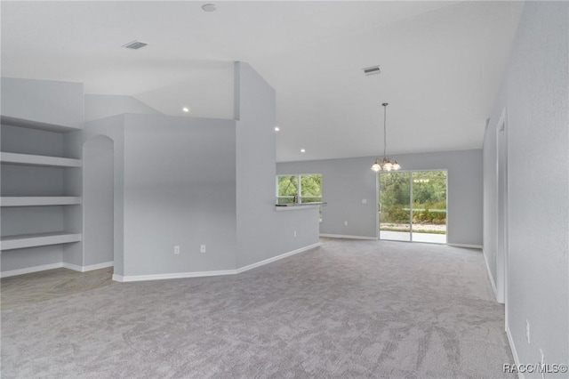 unfurnished living room with lofted ceiling, a chandelier, light carpet, and built in features