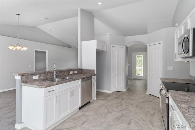 kitchen featuring pendant lighting, sink, lofted ceiling, stainless steel appliances, and white cabinets