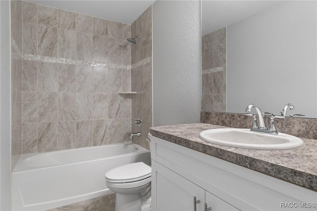 full bathroom featuring tiled shower / bath combo, vanity, and toilet