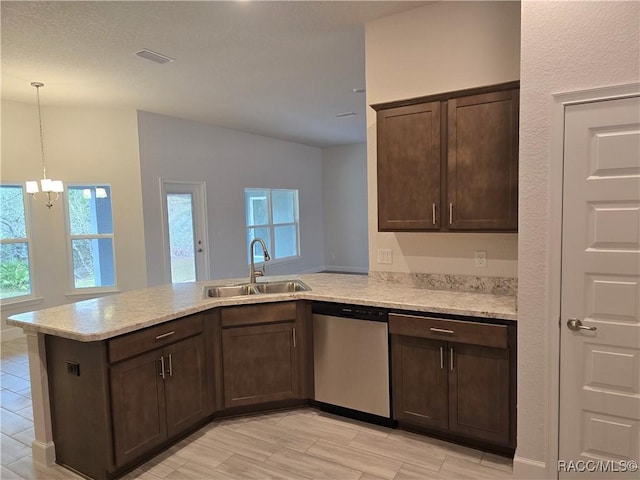 kitchen featuring dark brown cabinetry, sink, stainless steel dishwasher, and kitchen peninsula