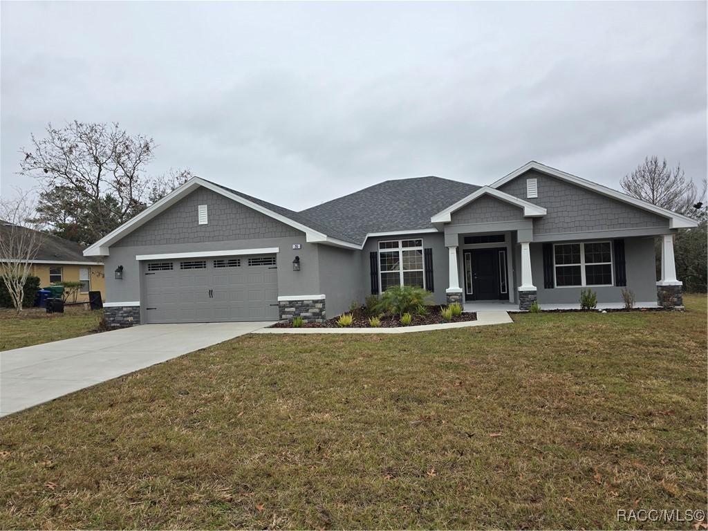 craftsman-style home featuring a garage and a front yard