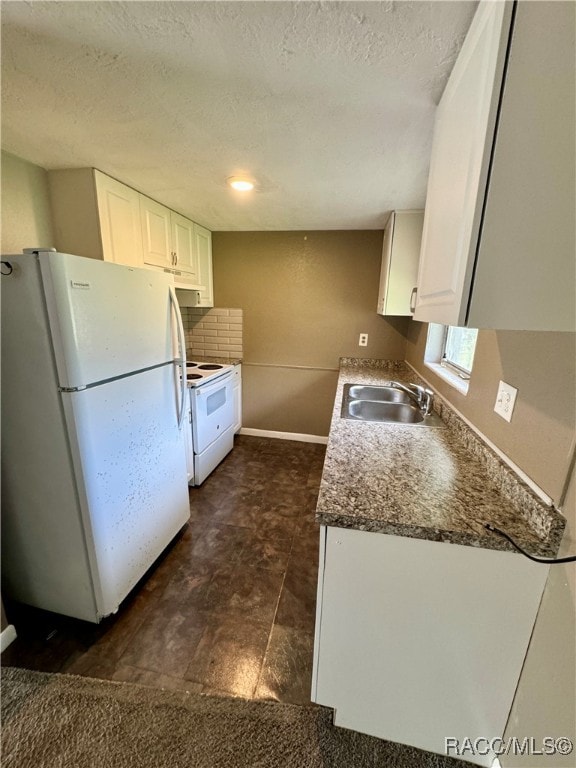 kitchen with sink, dark stone counters, a textured ceiling, white appliances, and white cabinets