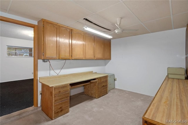 unfurnished office with ceiling fan and light colored carpet