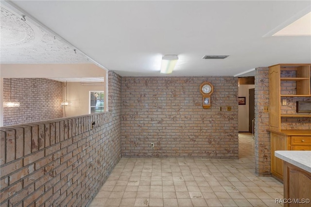 basement featuring brick wall