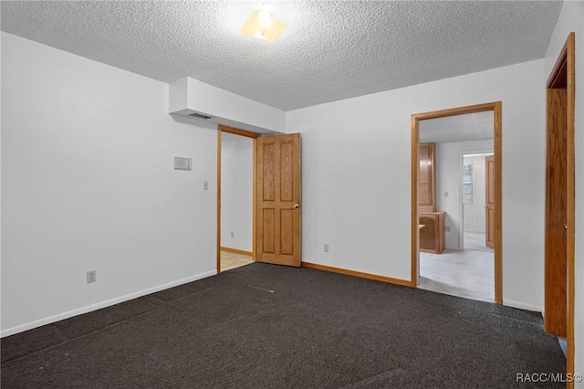 unfurnished bedroom featuring carpet and a textured ceiling