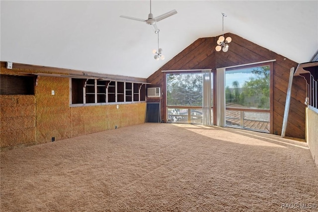 unfurnished living room with carpet flooring, a wall mounted AC, ceiling fan, and lofted ceiling