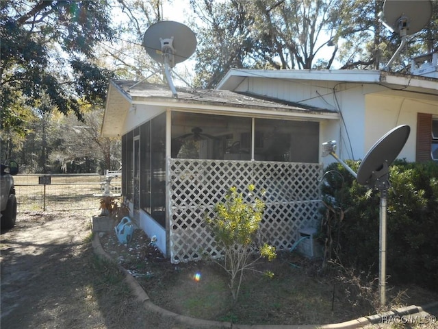 view of property exterior featuring a sunroom