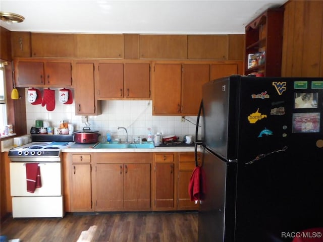 kitchen with white range with electric stovetop, sink, backsplash, dark hardwood / wood-style flooring, and black fridge