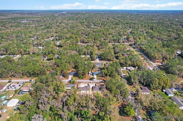 drone / aerial view featuring a residential view and a forest view