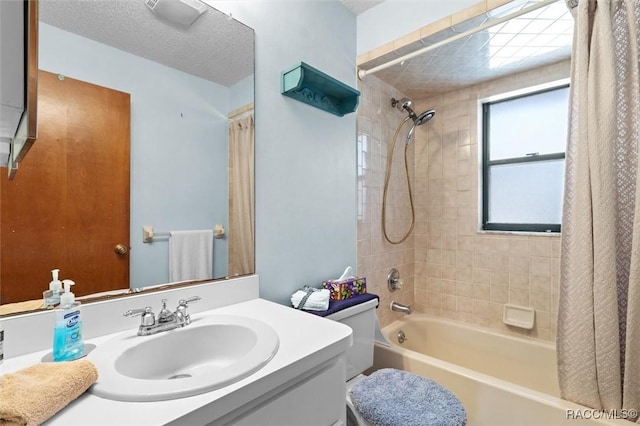 bathroom with toilet, vanity, a textured ceiling, and shower / tub combo with curtain