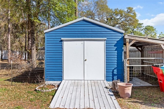 view of shed featuring fence