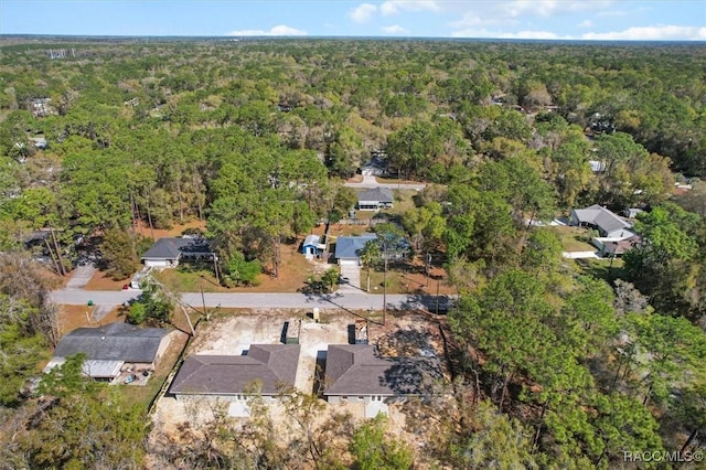 birds eye view of property with a wooded view and a residential view