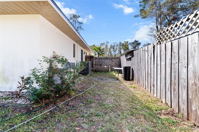 view of yard with central AC unit and a fenced backyard