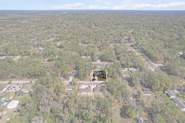 drone / aerial view featuring a view of trees