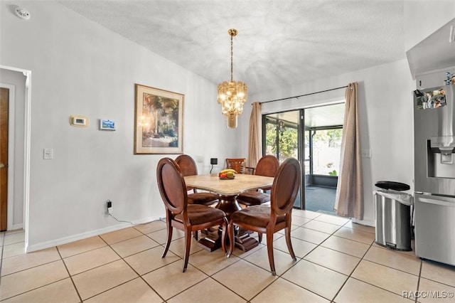 dining space with light tile patterned floors, baseboards, an inviting chandelier, lofted ceiling, and a textured ceiling