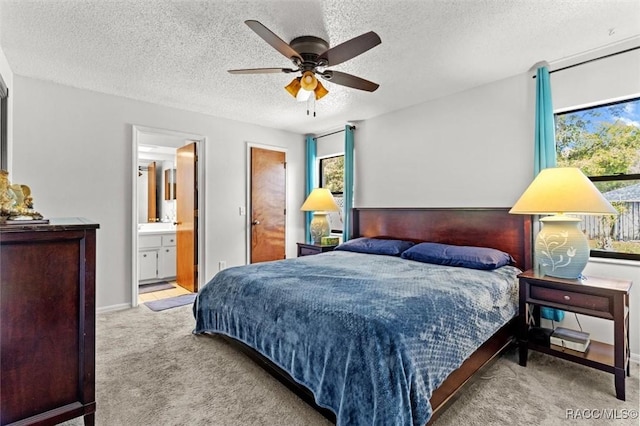 bedroom featuring a ceiling fan, multiple windows, carpet, and a textured ceiling