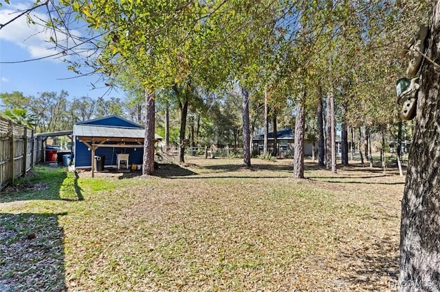 view of yard with an outbuilding and fence