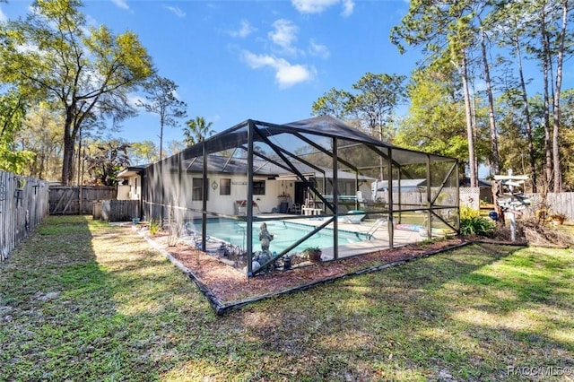 view of pool featuring a lawn, a patio, a fenced backyard, a fenced in pool, and a lanai