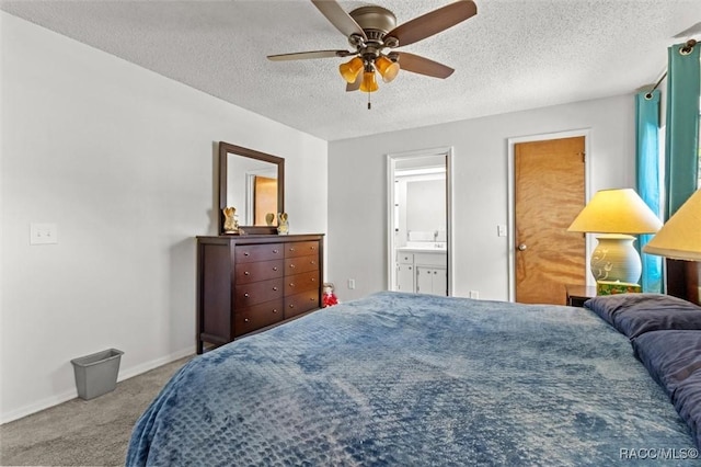 carpeted bedroom featuring ensuite bath, ceiling fan, a textured ceiling, and baseboards