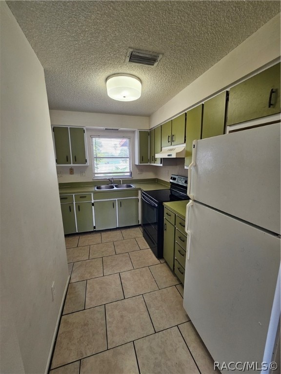 kitchen featuring black range with electric cooktop, sink, white refrigerator, green cabinets, and light tile patterned flooring