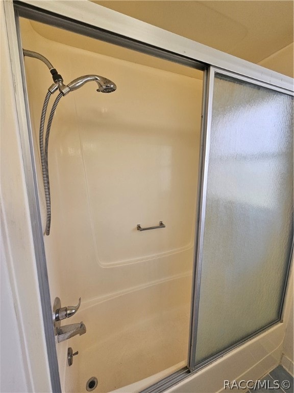 bathroom with shower / bath combination with glass door