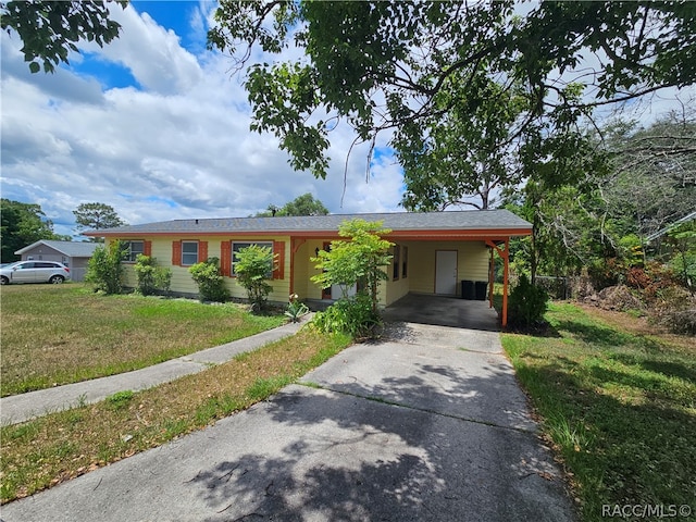 single story home with a front yard and a carport