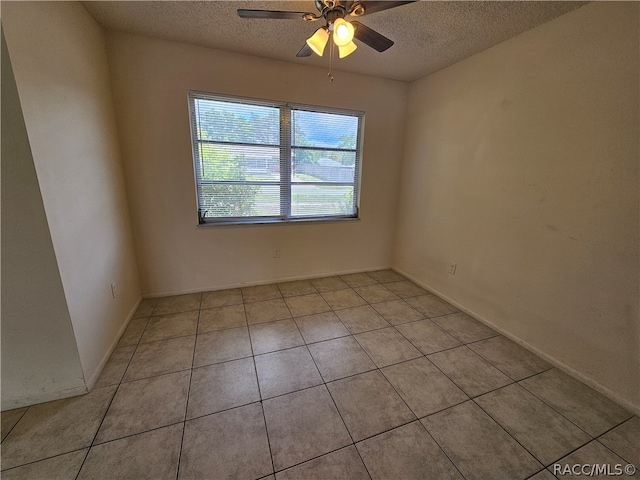 tiled spare room featuring ceiling fan and a textured ceiling